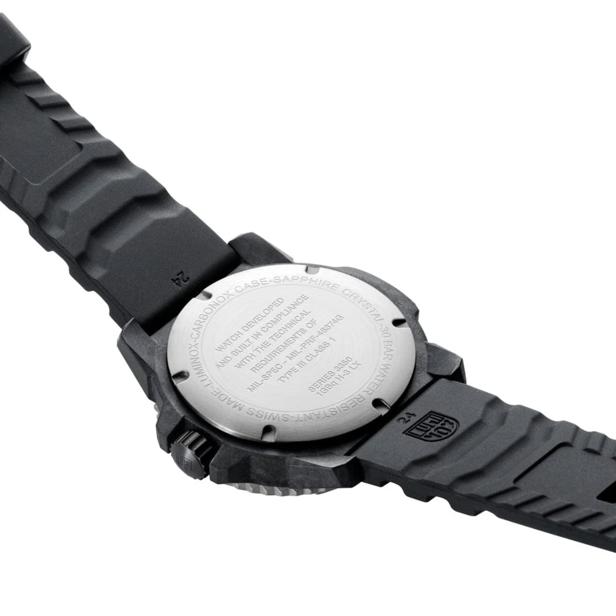 Black rubber watch caseback with engraved text and serrated bezel edges