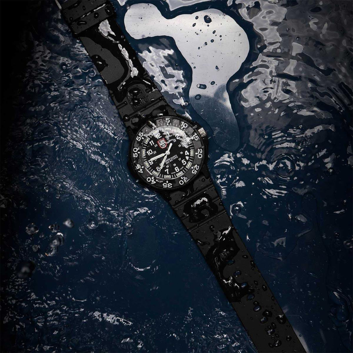 Luminox Navy Seal black dial rubber quartz watch resting on wet surface, round black bezel