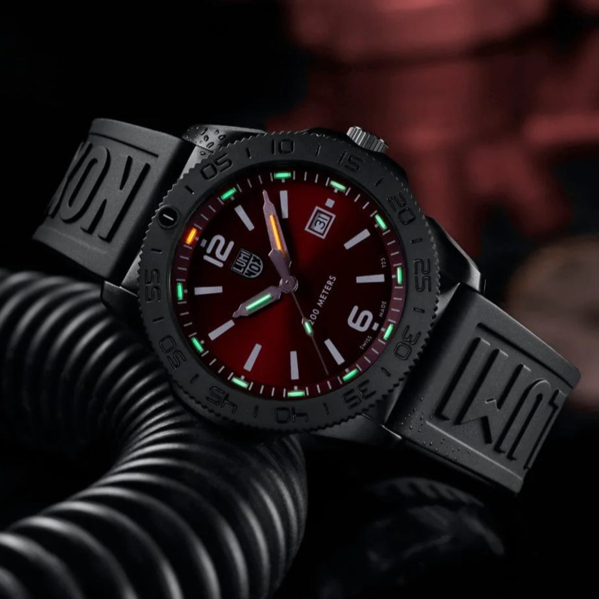 Luminox Pacific Diver watch with deep red dial and glowing tritium night illumination