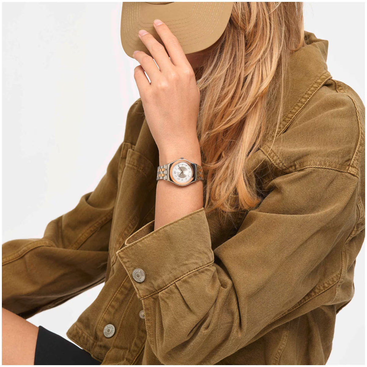 Ladies watch on wrist with white dial and rose-toned steel bracelet