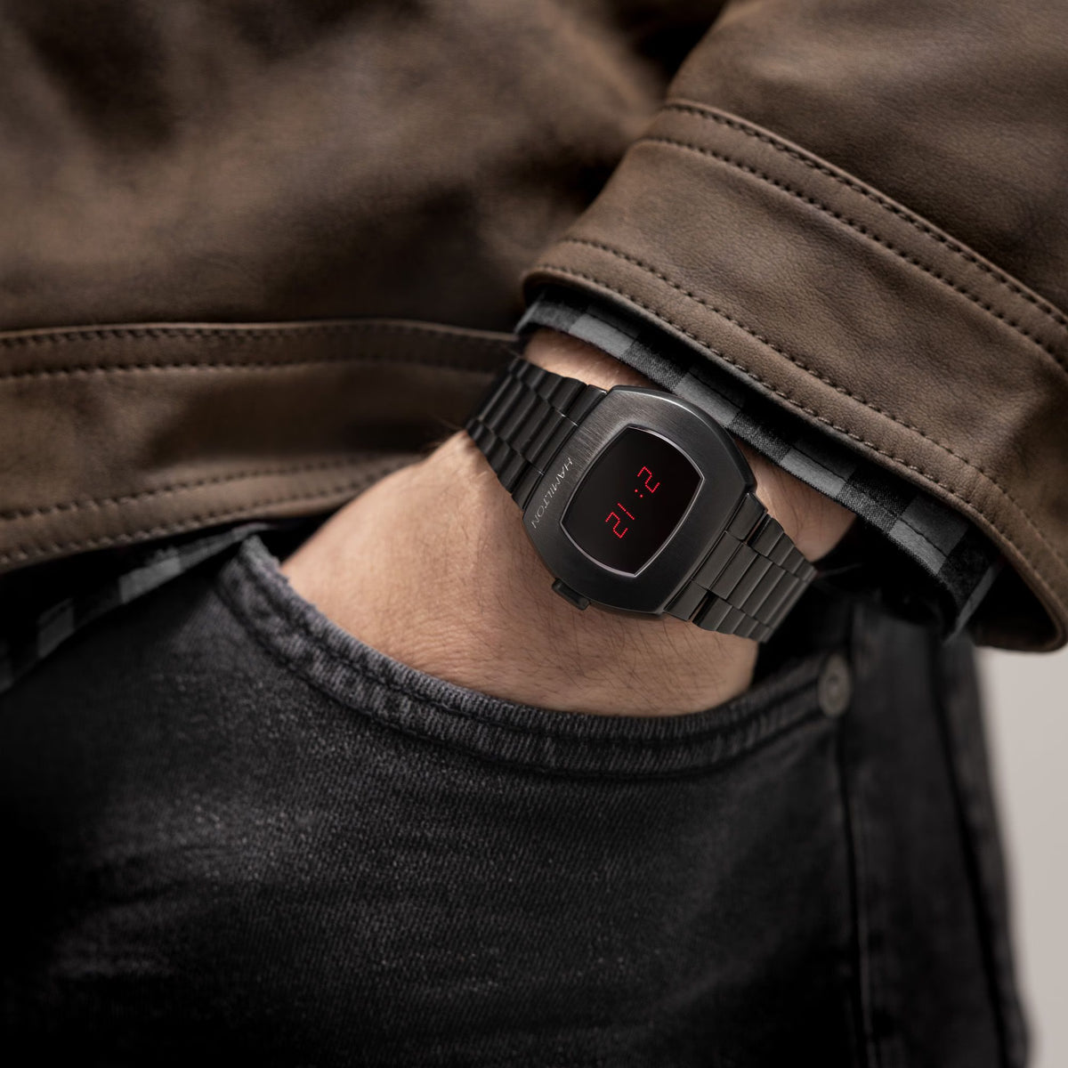 Men's black digital watch on wrist with red LED time display