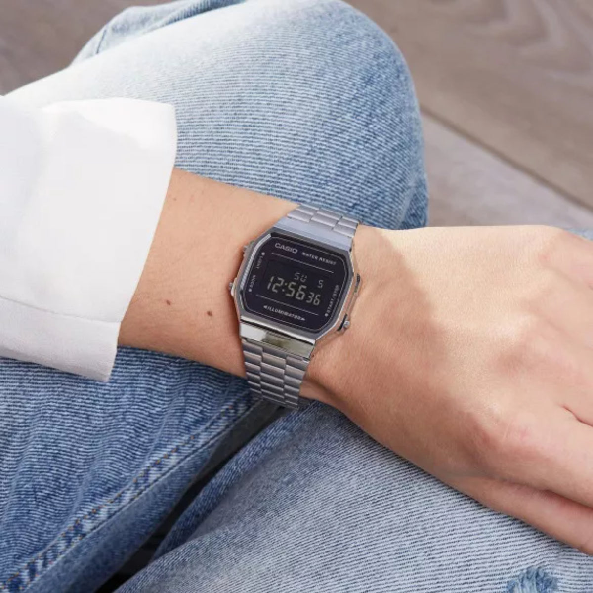 On-wrist lifestyle shot showing the Casio Vintage Retro A168WEM-1EF digital steel watch worn casually with denim