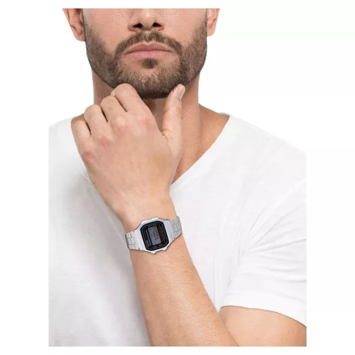 Model wearing the Casio Vintage Retro A168WEM-1EF steel Illuminator digital watch paired with a plain white t-shirt