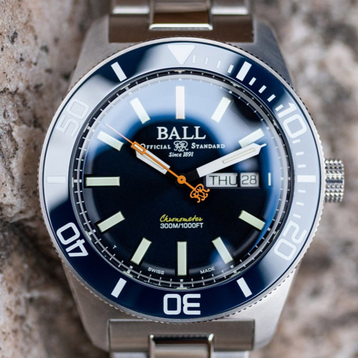 Diver watch with light blue dial, dark center, and rotating bezel with luminous markers