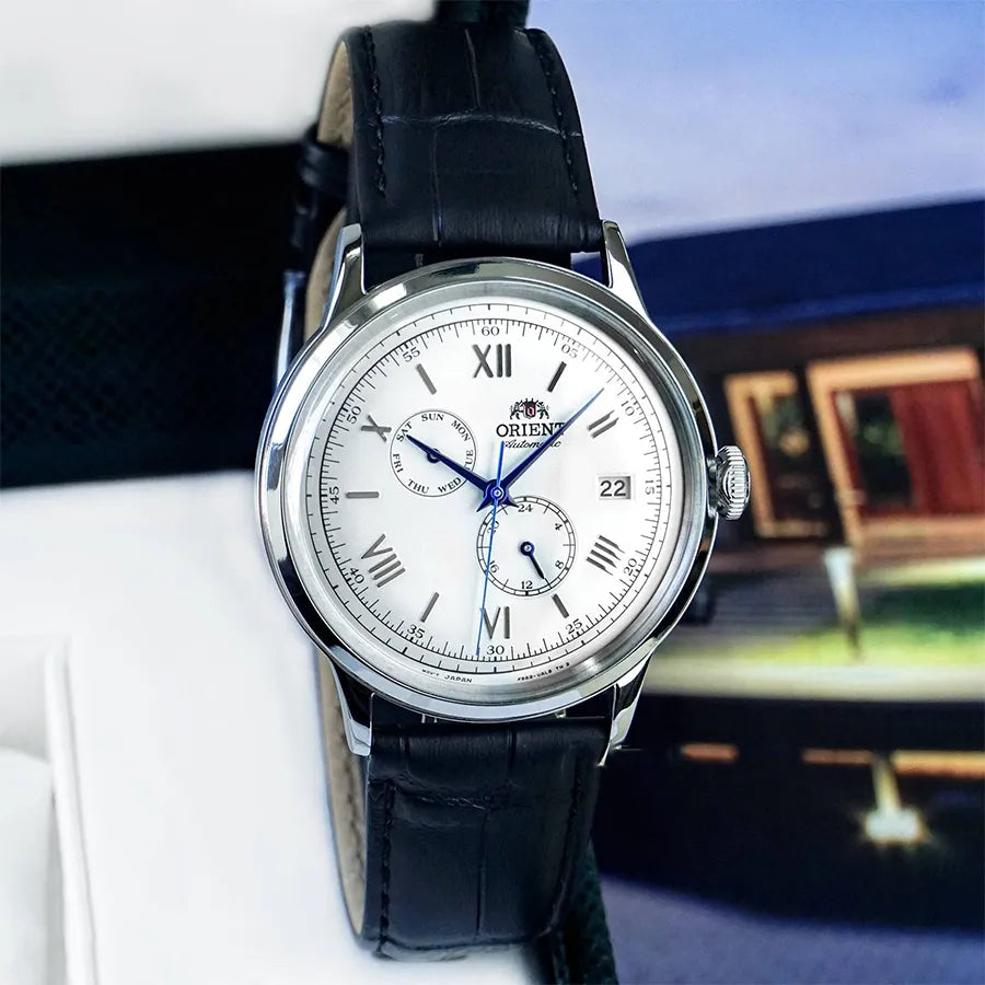 Front angle of Orient Bambino RA-AK0701S30B wristwatch with multi-dial display and polished steel case.