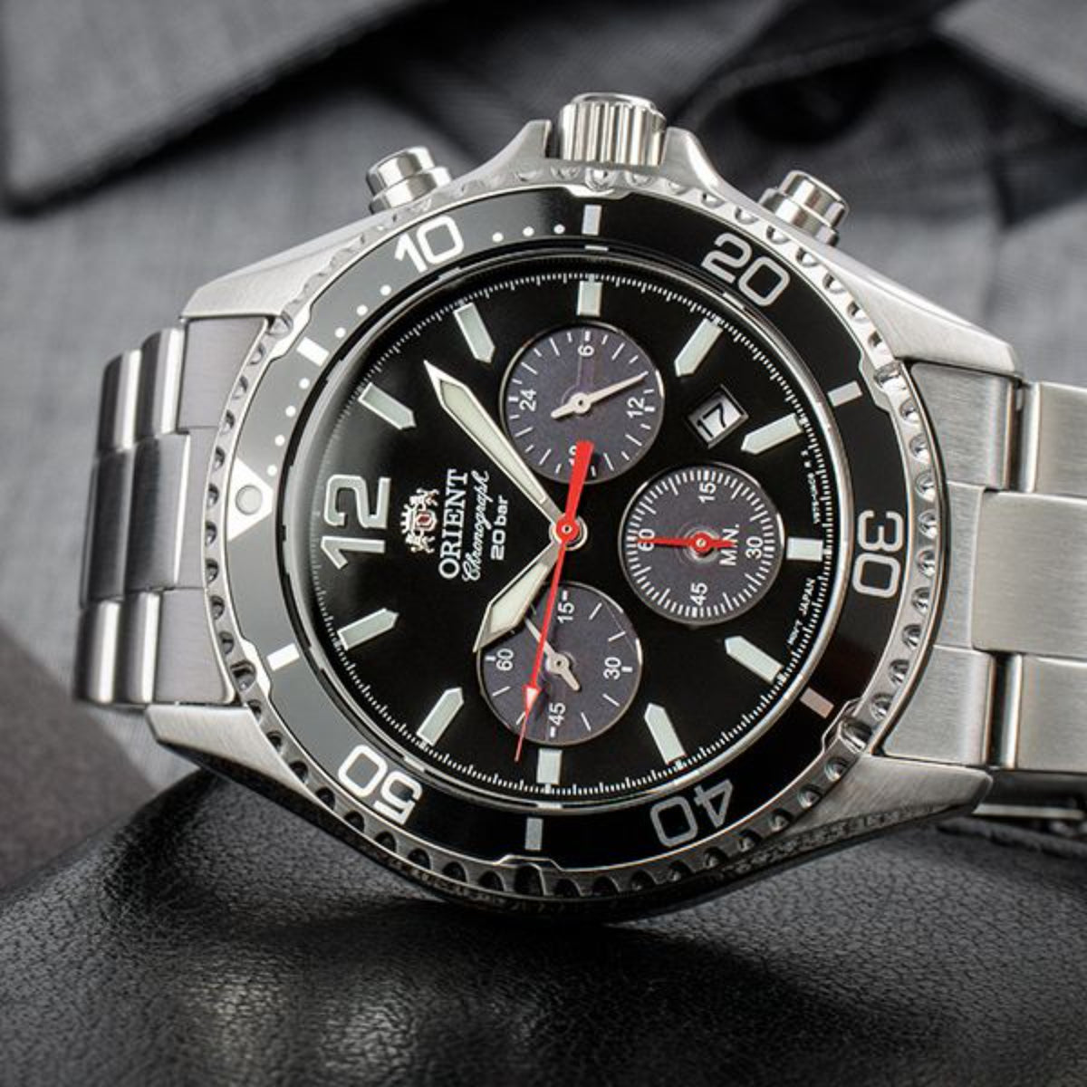 Steel chronograph watch with black dial, red seconds hand, three subdials.