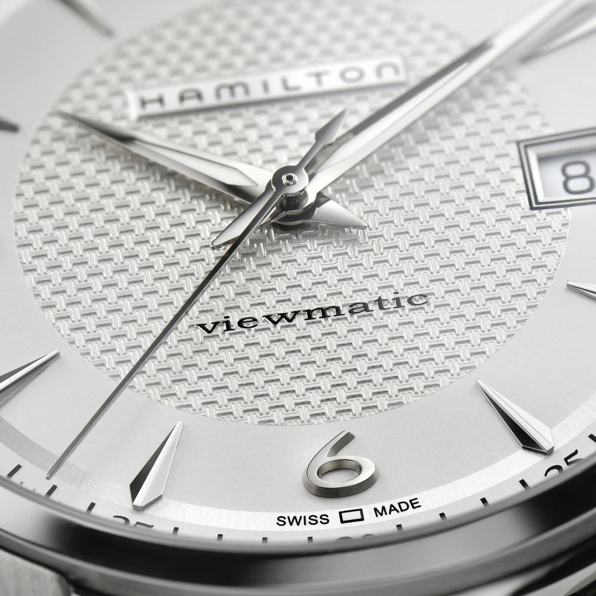 Hamilton Viewmatic watch dial close-up with silver hands and textured white face