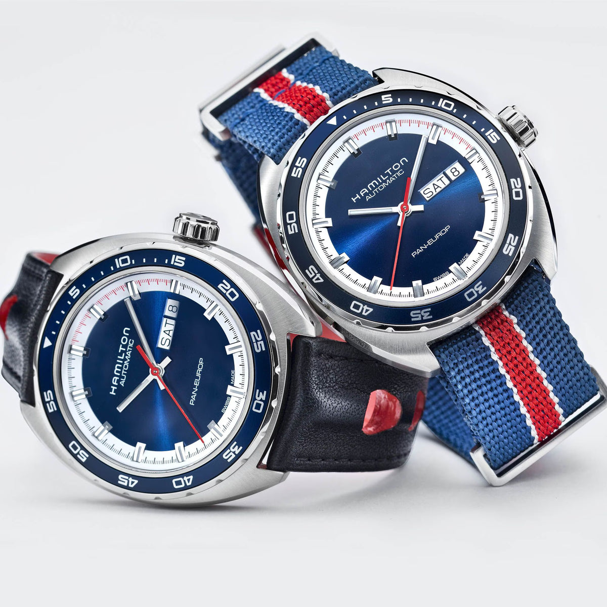 Two Hamilton Pan-Europ watches with blue dials, featuring a black leather strap and a striped textile NATO strap