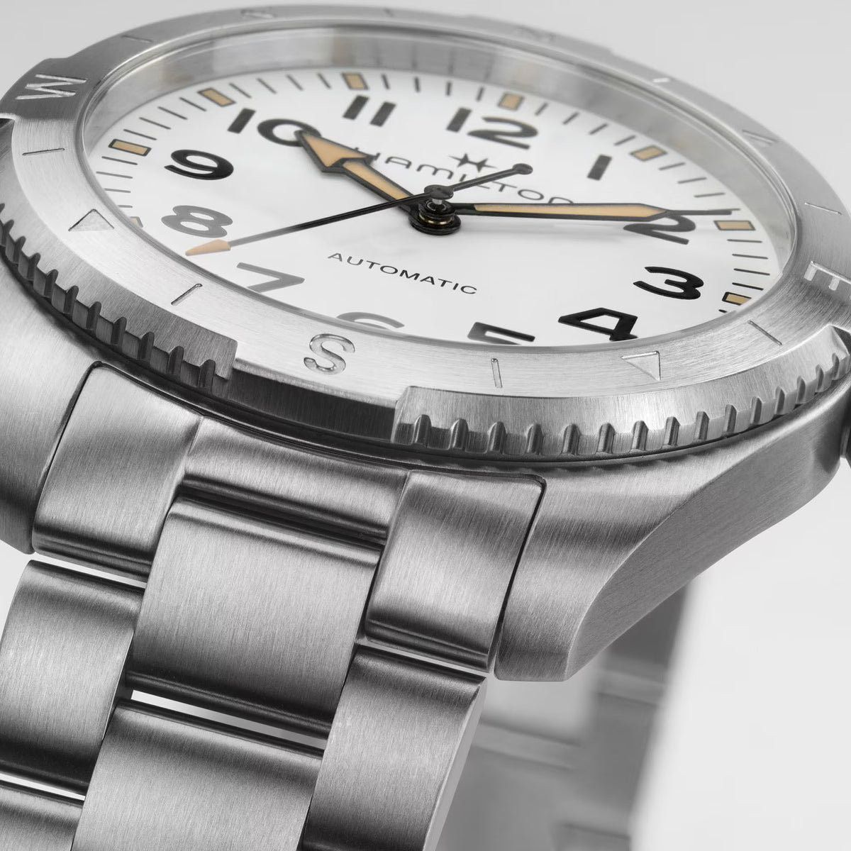 Hamilton Khaki Field Expedition H70315110 angled view showcasing white dial and compass bezel detail