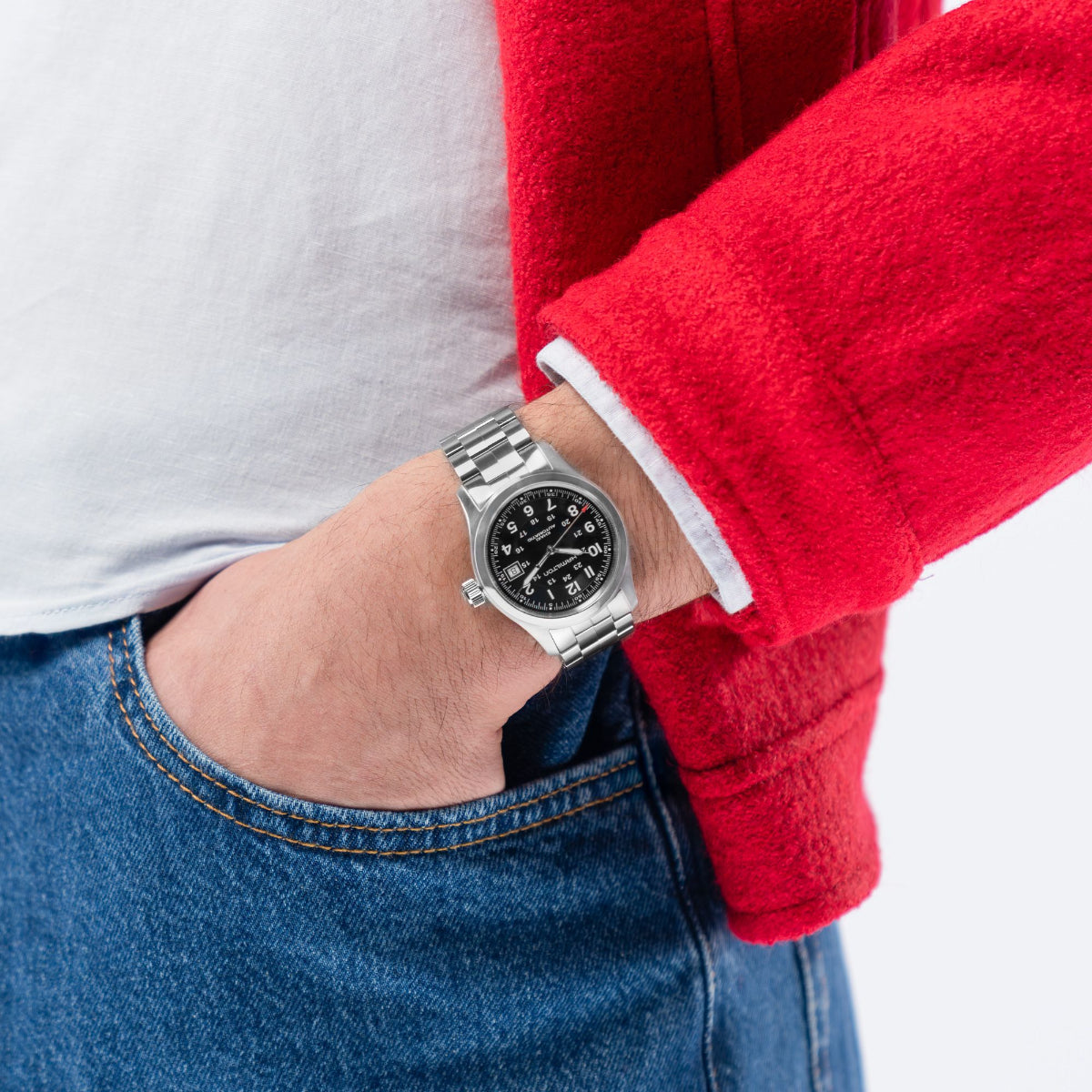 Full wrist perspective of the Hamilton Khaki Field H70455133 field watch tucked near a trouser pocket