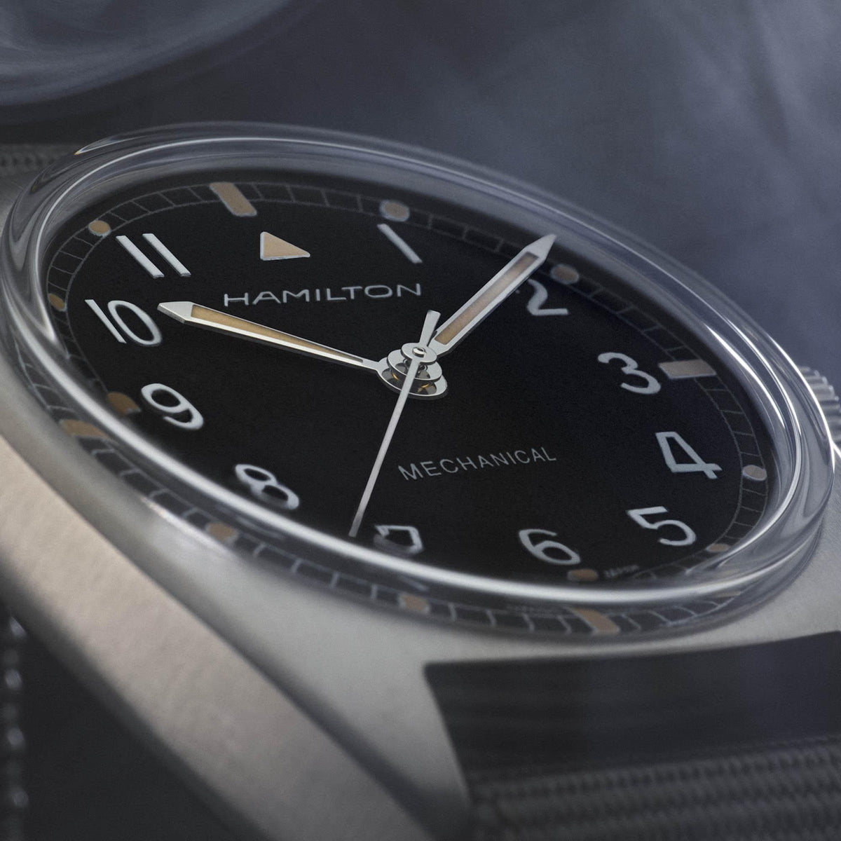 Hamilton mechanical pilot watch dial close-up with black face and gold accents