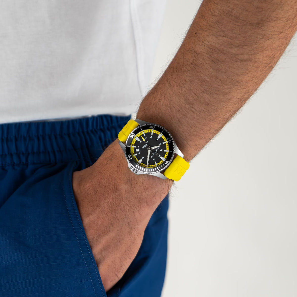 Men's Hamilton automatic watch on wrist, yellow rubber strap and black dial with yellow trim