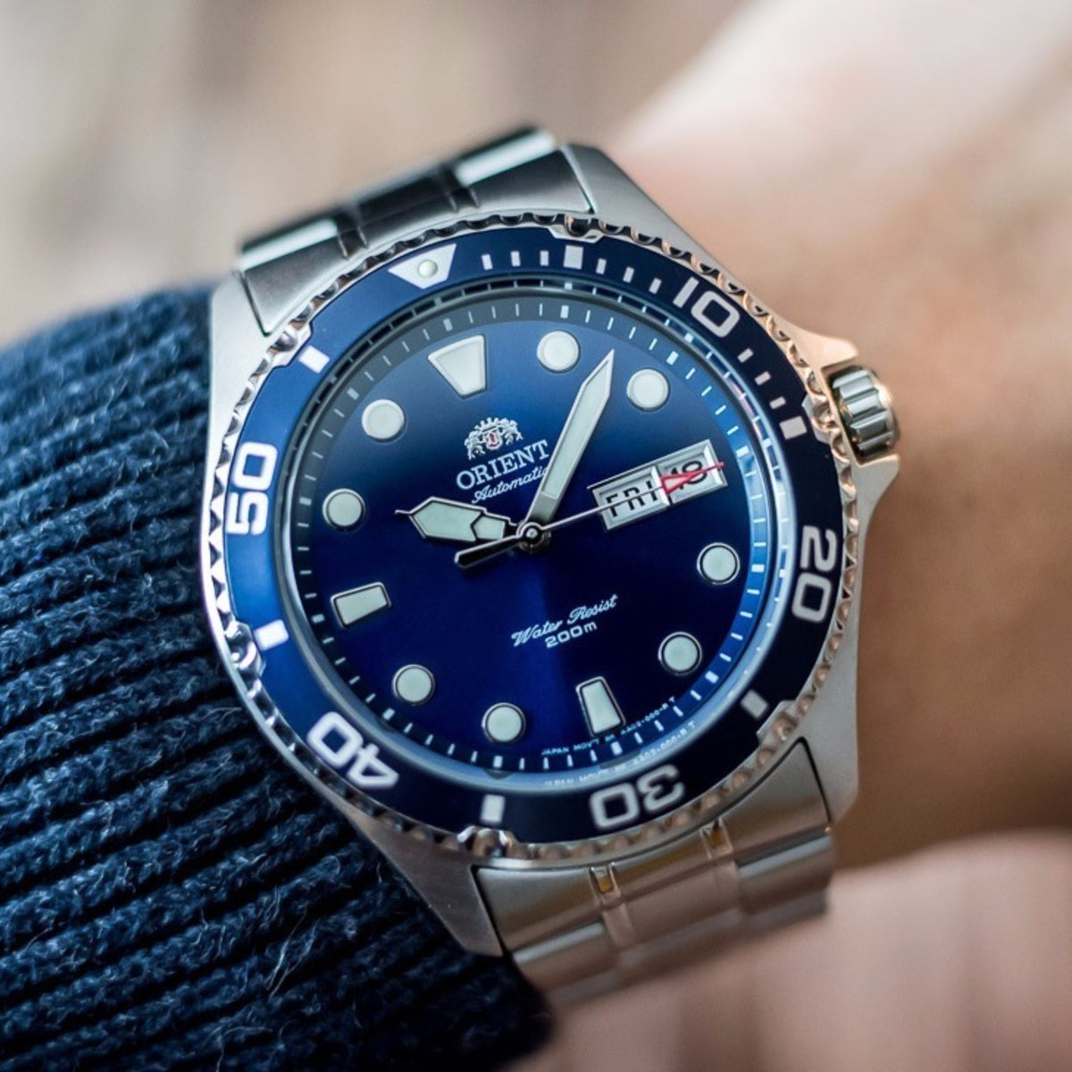 Orient automatic diver watch with blue dial, steel bracelet, and black bezel