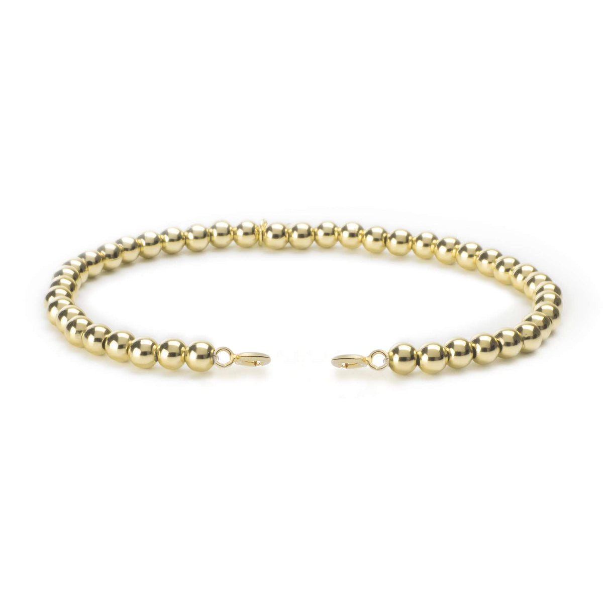 Gold beaded bracelet with small dangling charm and hook clasp