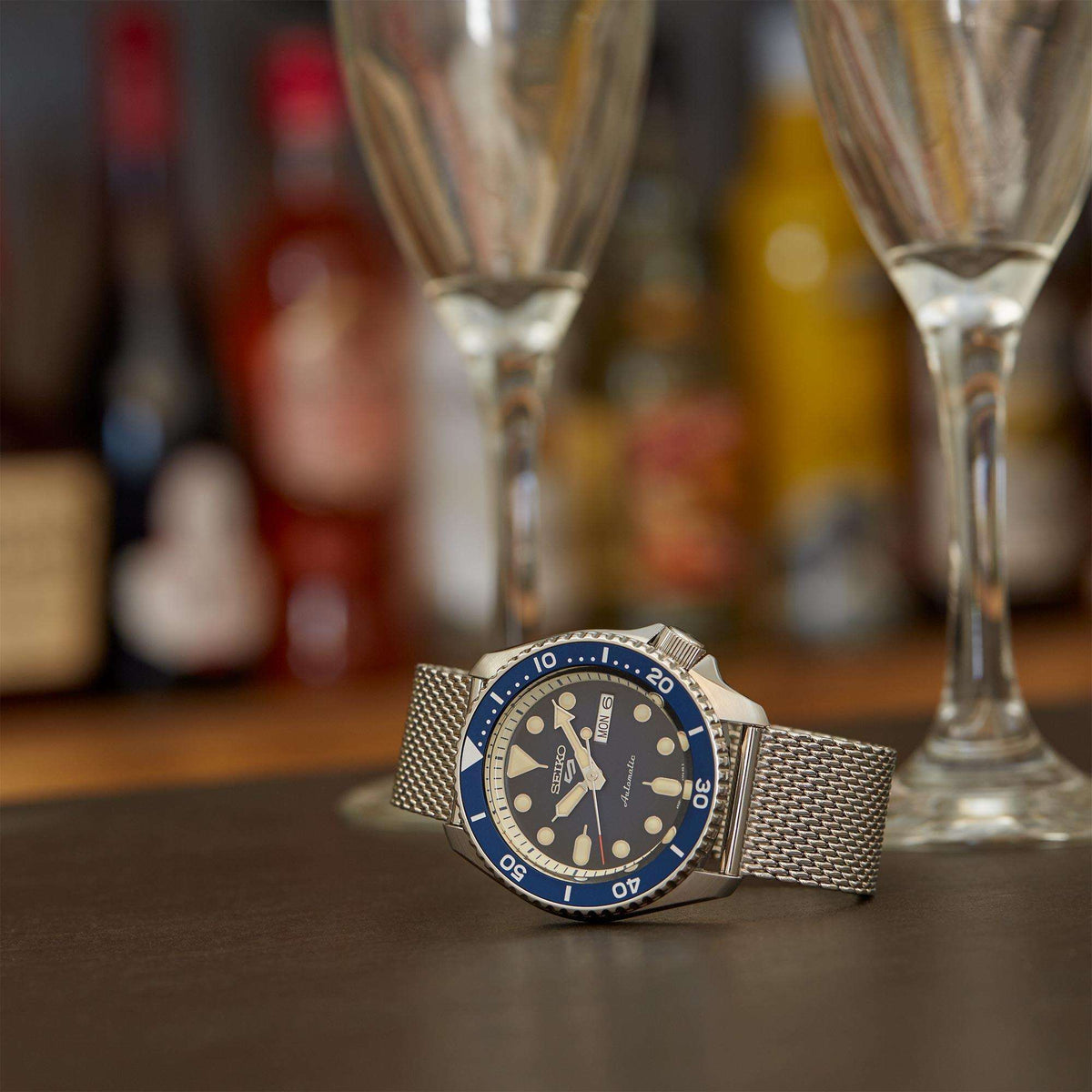 Silver automatic men's watch on steel mesh bracelet with blue dial and bezel