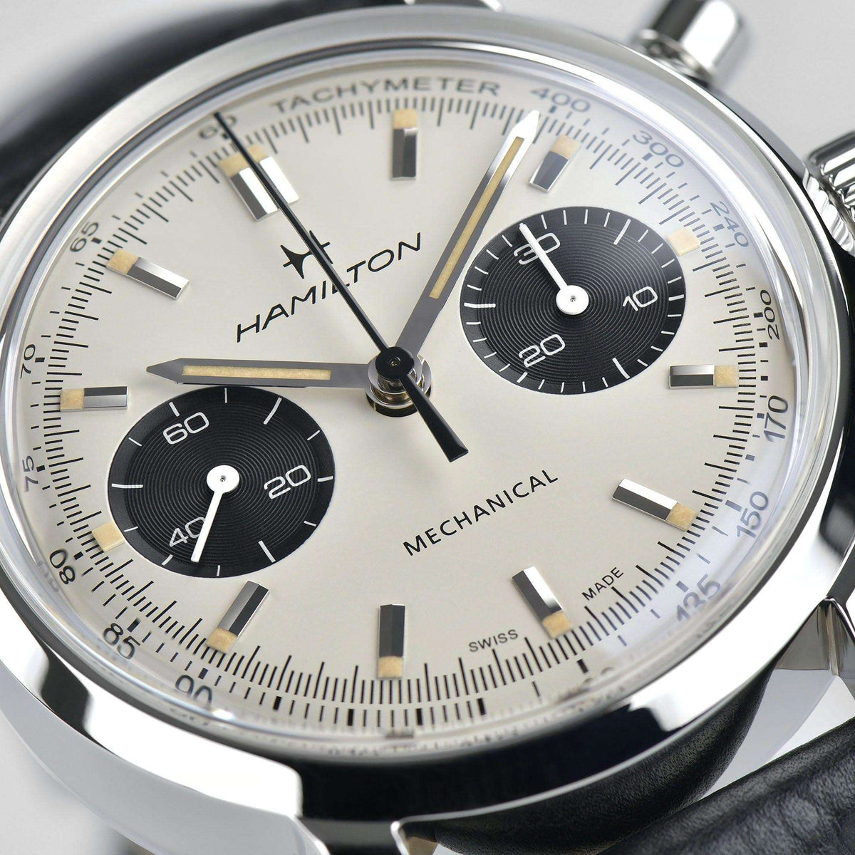Hamilton chronograph watch dial close-up with tachymeter scale, black subdial and markers