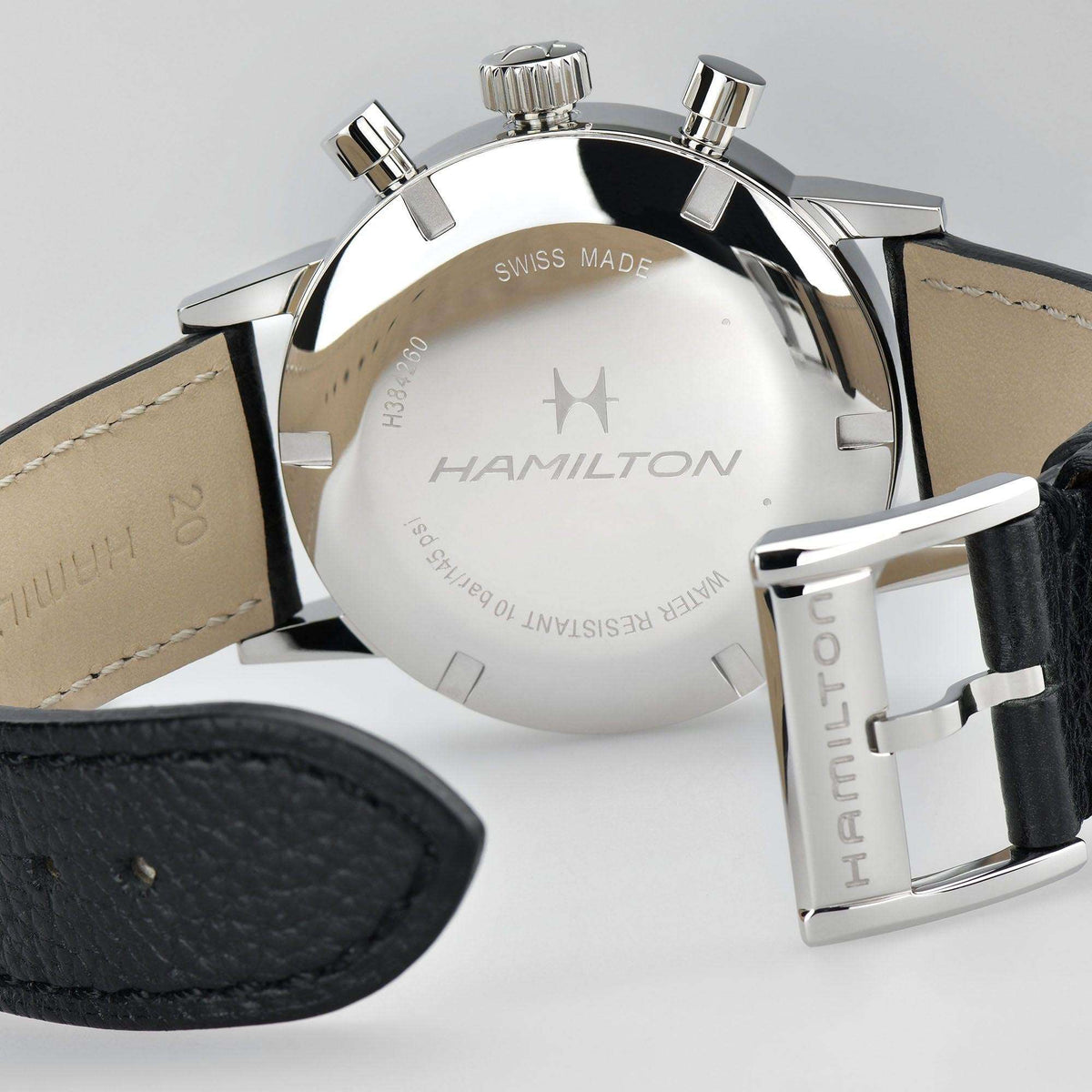 Hamilton watch caseback with Swiss Made text and black leather strap, stainless steel finish