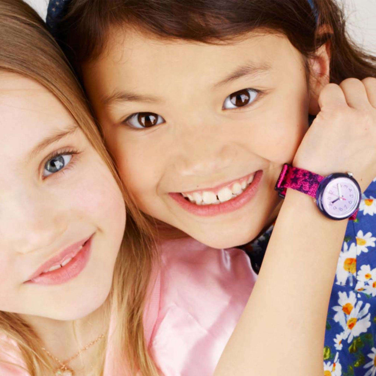Girls quartz wristwatch with purple dial and glitter purple strap, worn by two kids