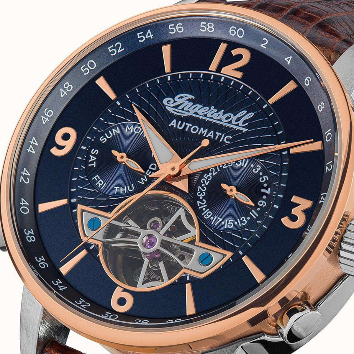 Men's automatic watch close-up: blue dial with roman numerals, brown leather strap, open movement