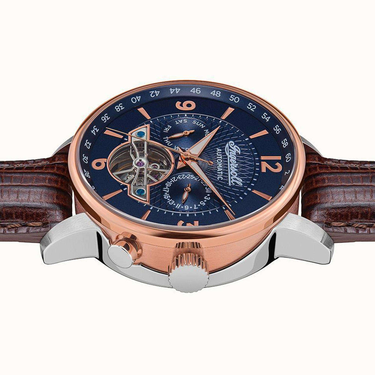Men's automatic watch angled view with blue dial, brown leather strap, rose-gold bezel detail