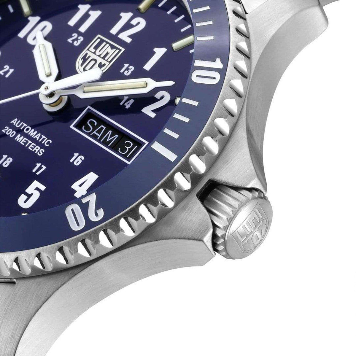 Men's automatic wristwatch close-up of blue dial, bezel, and side crown