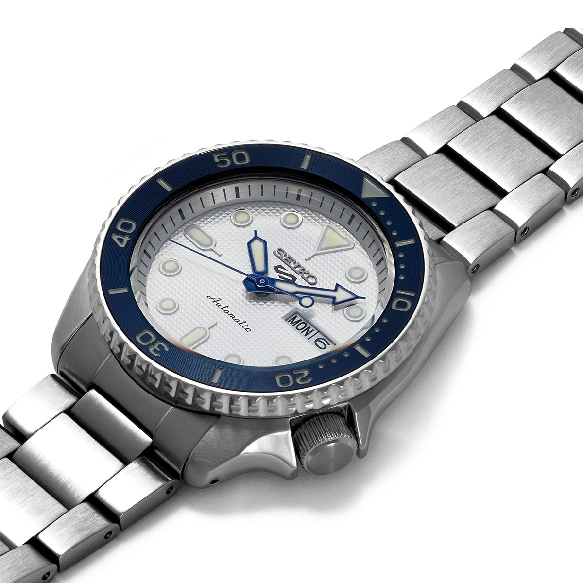 Seiko 5 Sports SRPG47K1 high-angle view showing textured white dial and blue rotating bezel