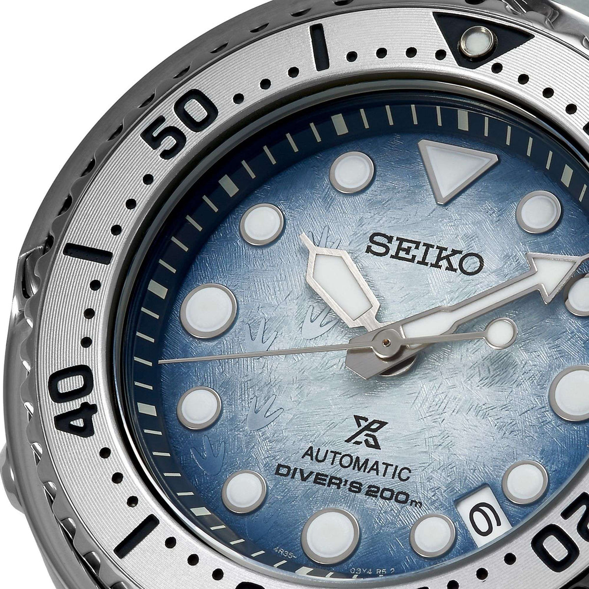 Close-up of men's blue dial automatic diver watch with SEIKO hands and markers