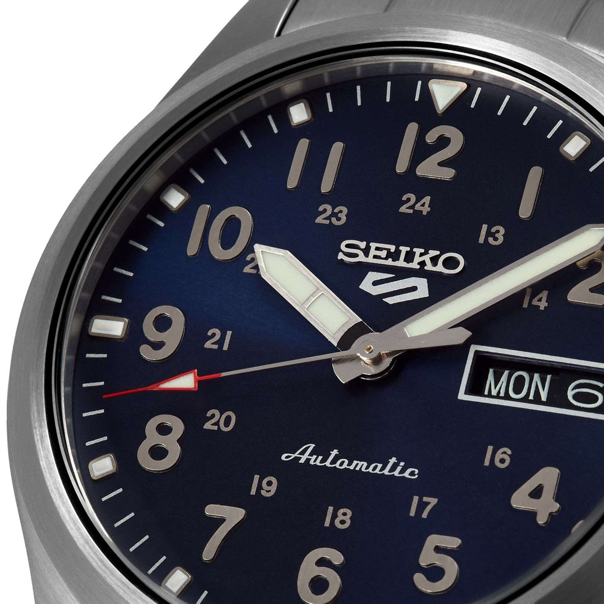Men's automatic watch face with blue dial, bold numerals, and MON day-date window