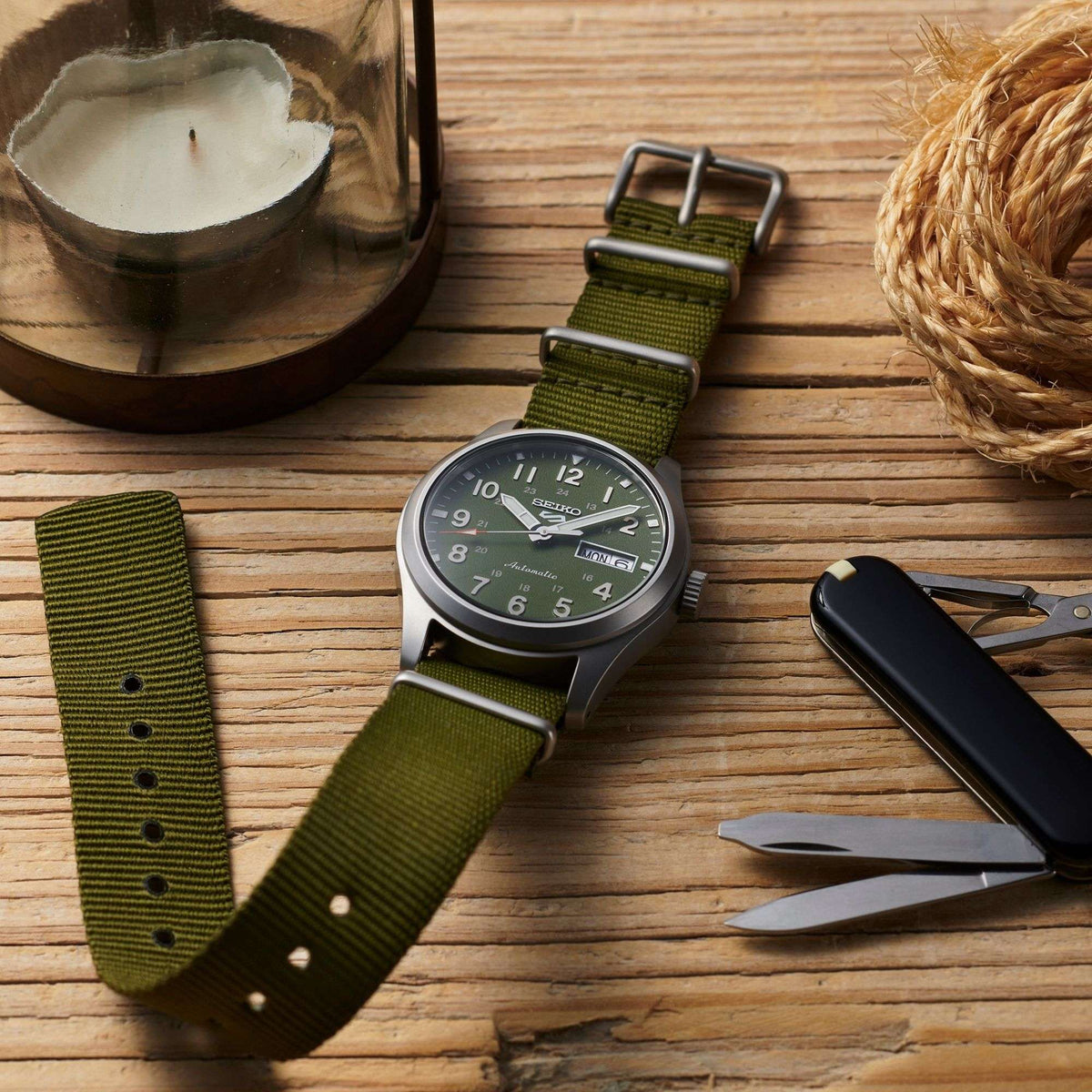 Seiko 5 Sports green NATO strap military watch on wooden surface