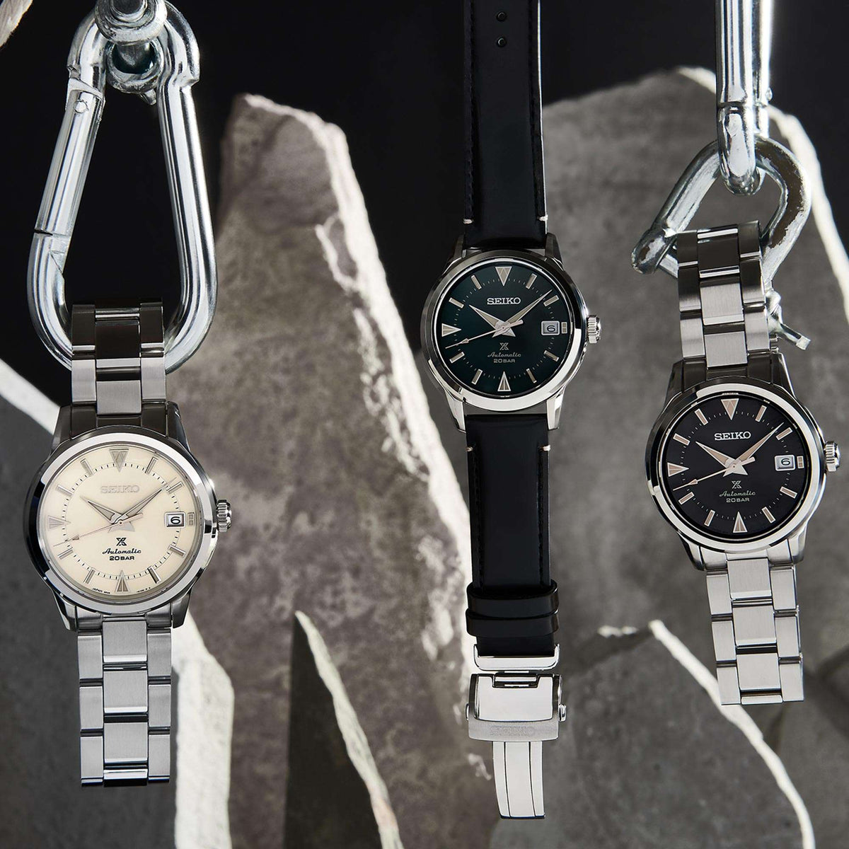 Stainless steel watch with black dial, gold markers, and date window on metal bracelet