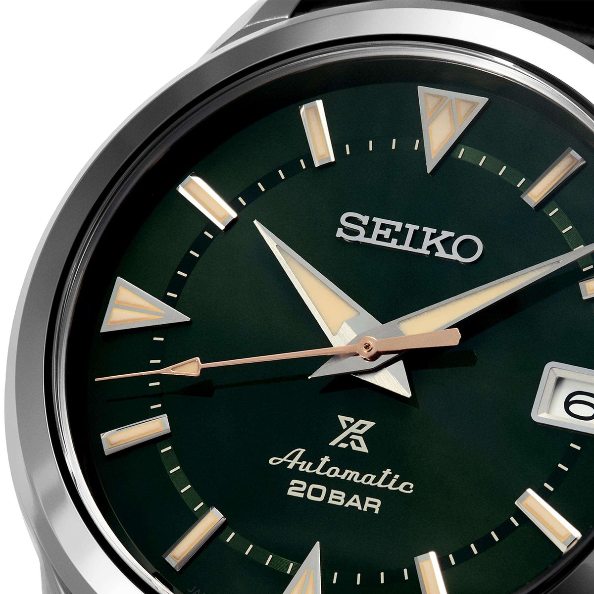 Green dial watch face with gold-tone hands, hour markers, and Automatic 20BAR