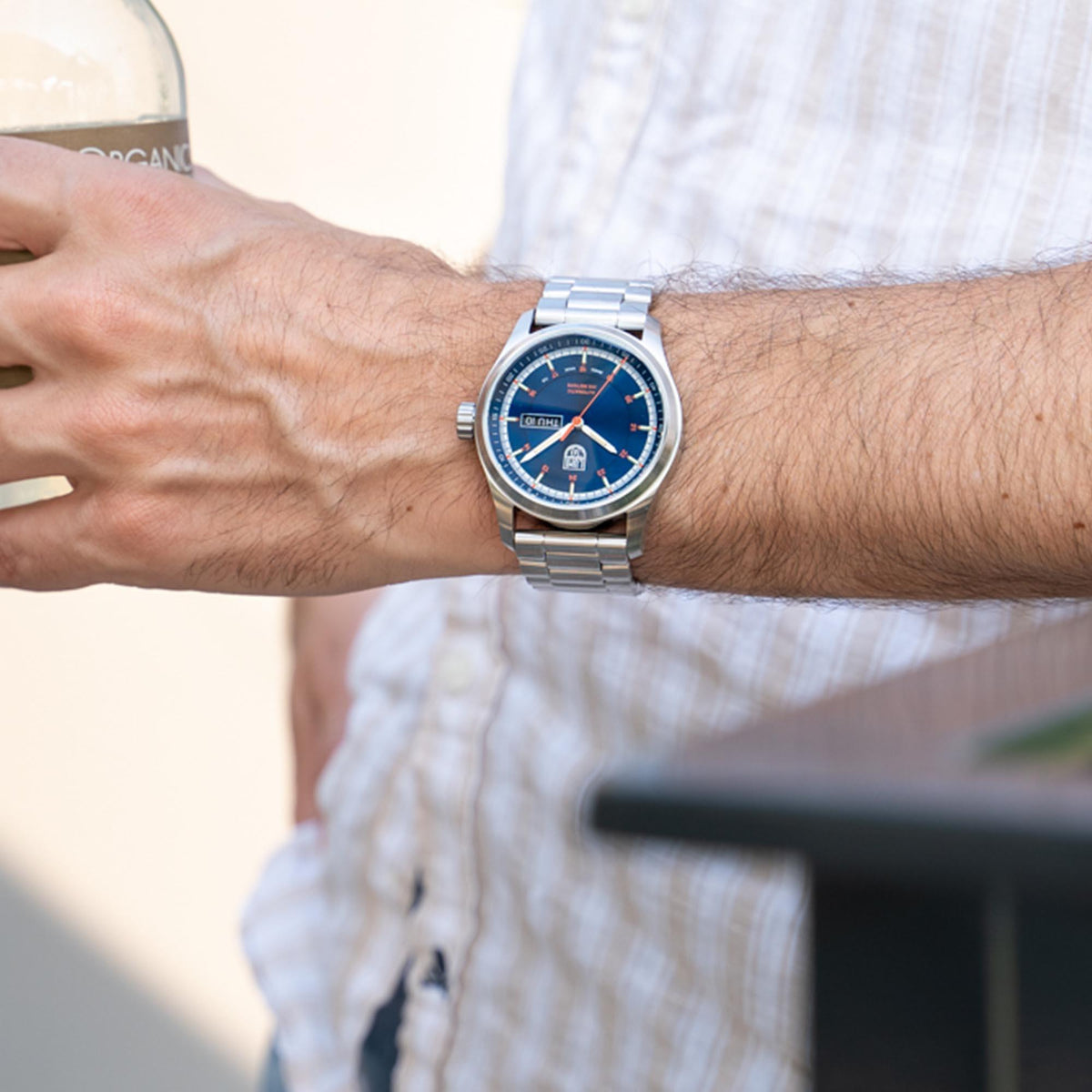 Men's automatic wristwatch on wrist, blue dial and silver steel bracelet