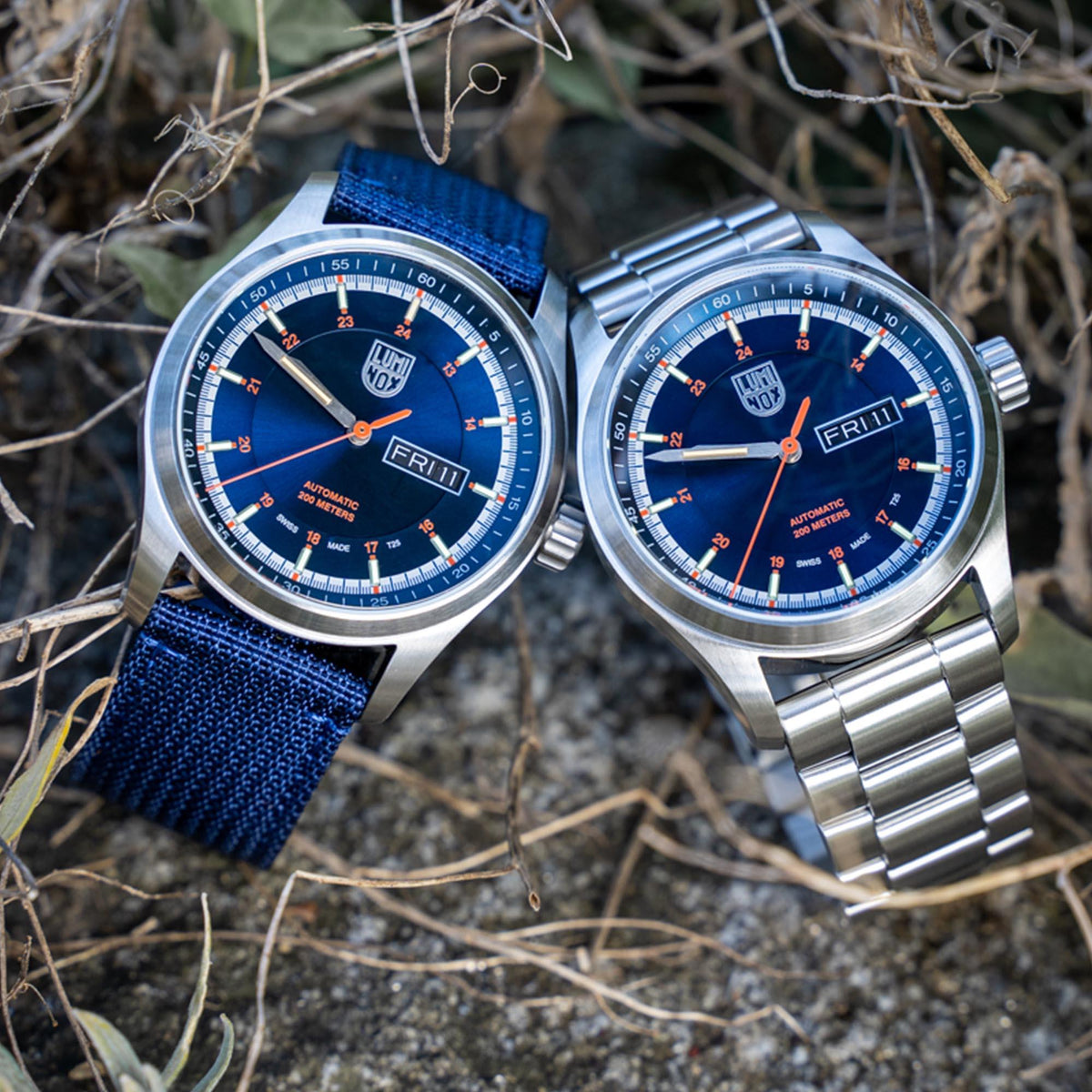 Men's automatic watch with blue dial, stainless steel case; shows fabric strap and bracelet