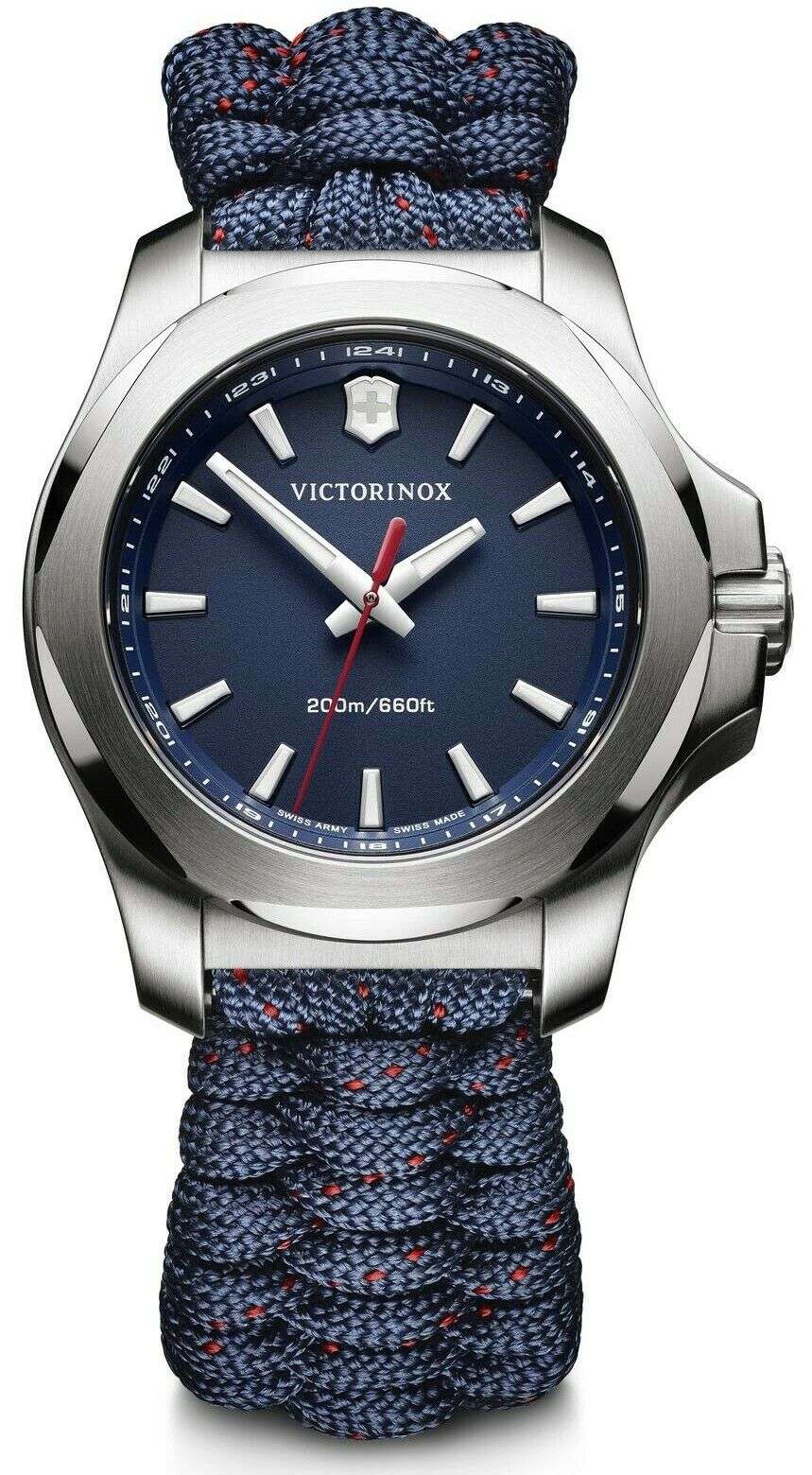 Silver quartz watch with dark blue dial, red second hand, and blue paracord strap.
