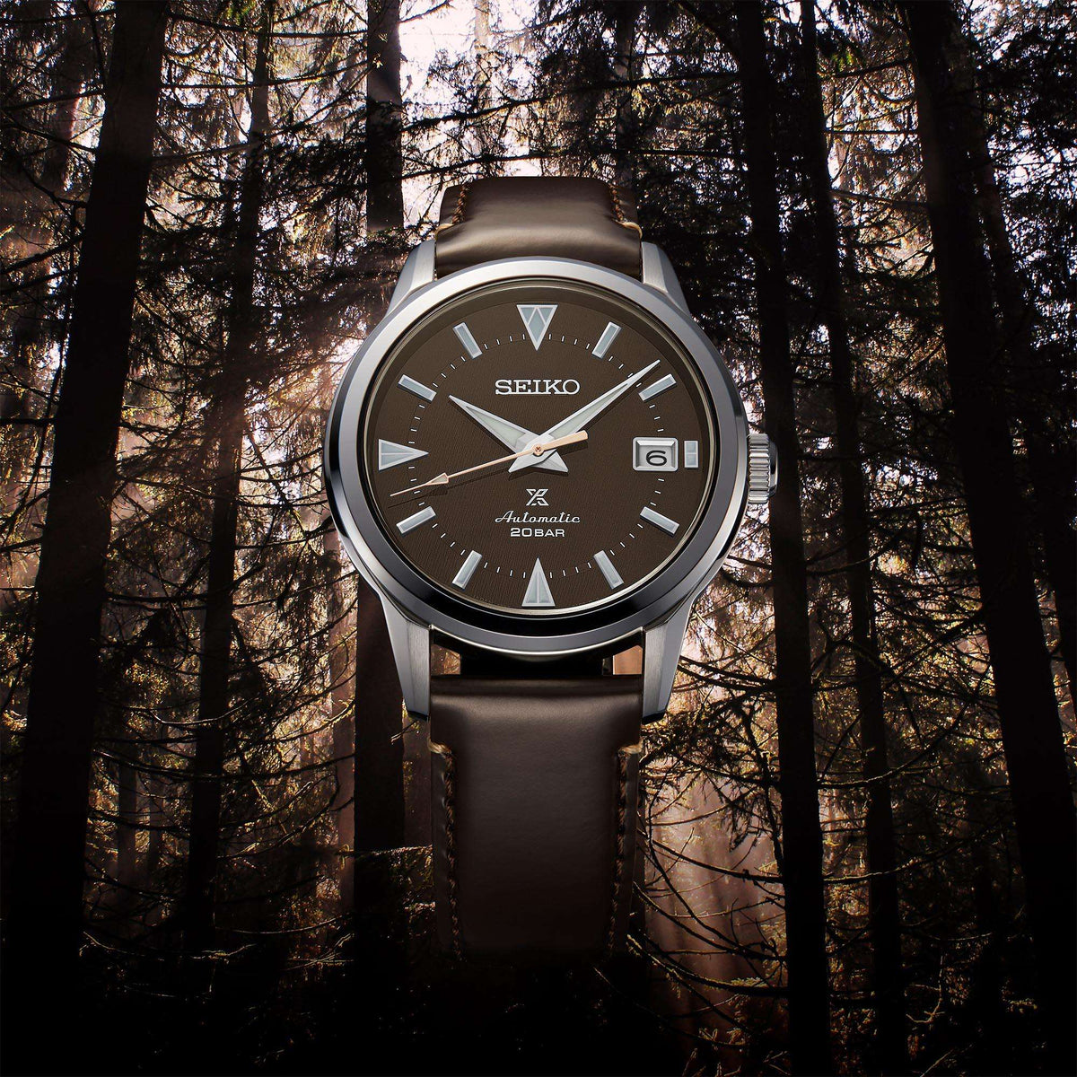 Men's automatic watch with brown dial, stainless case, and dark brown leather strap.