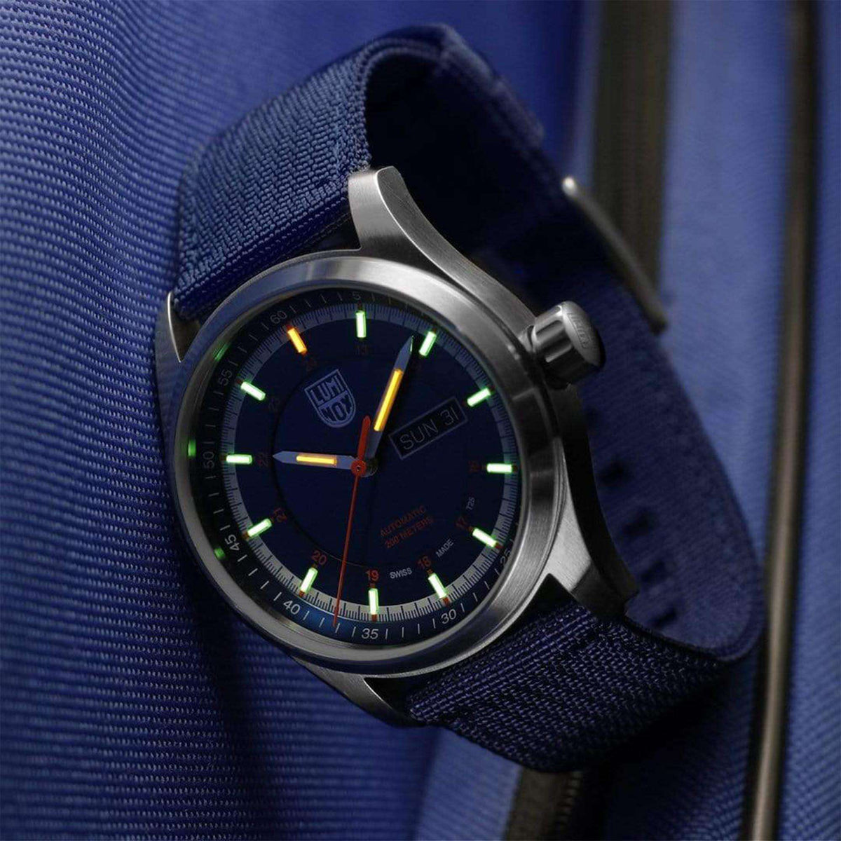 44mm field watch on blue fabric strap with dark blue dial and green luminous markers