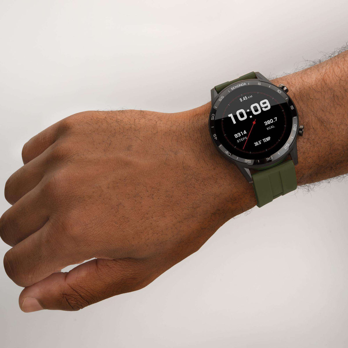 Men's smart watch with black case and green silicone strap, round fitness dial on wrist