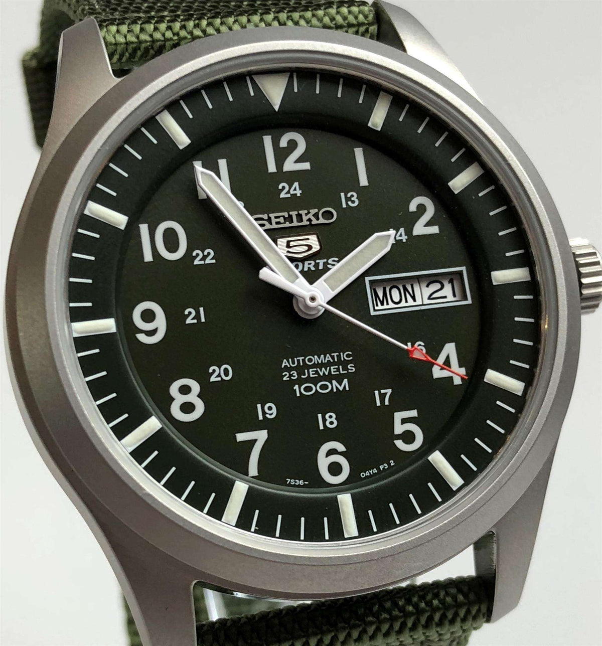 Men's diver-style automatic watch with dark green dial, red seconds, day-date