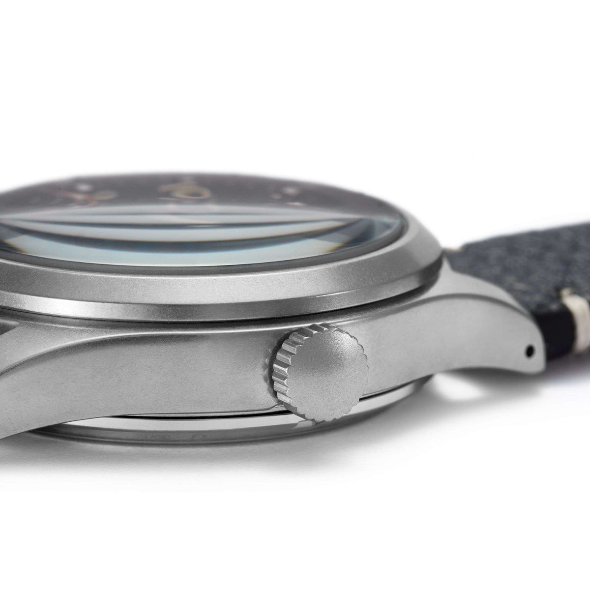 Men's automatic wristwatch side view with ridged crown and black leather strap