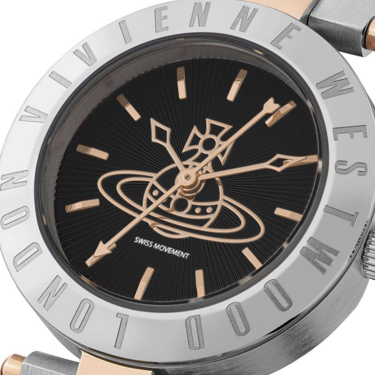 Black dial close-up with gold-tone emblem, gold hands, and raised hour bar markers