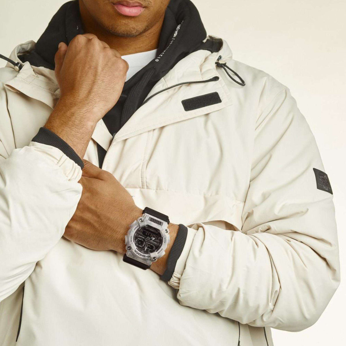 Casio G-Shock men’s wristwatch on model’s wrist, grey camo case, black dial, resin strap