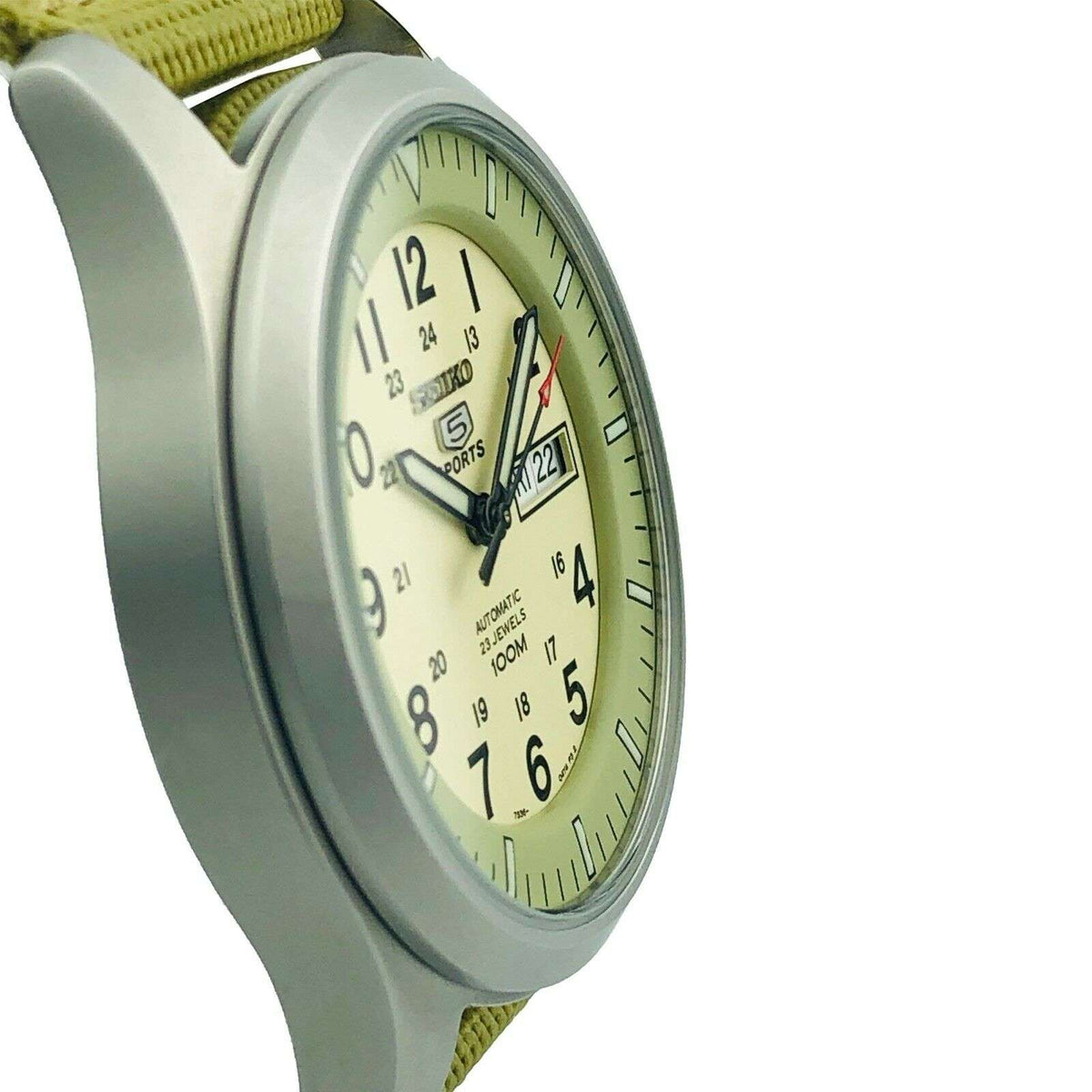 Seiko 5 Sports automatic watch with cream dial, olive canvas strap, and side profile
