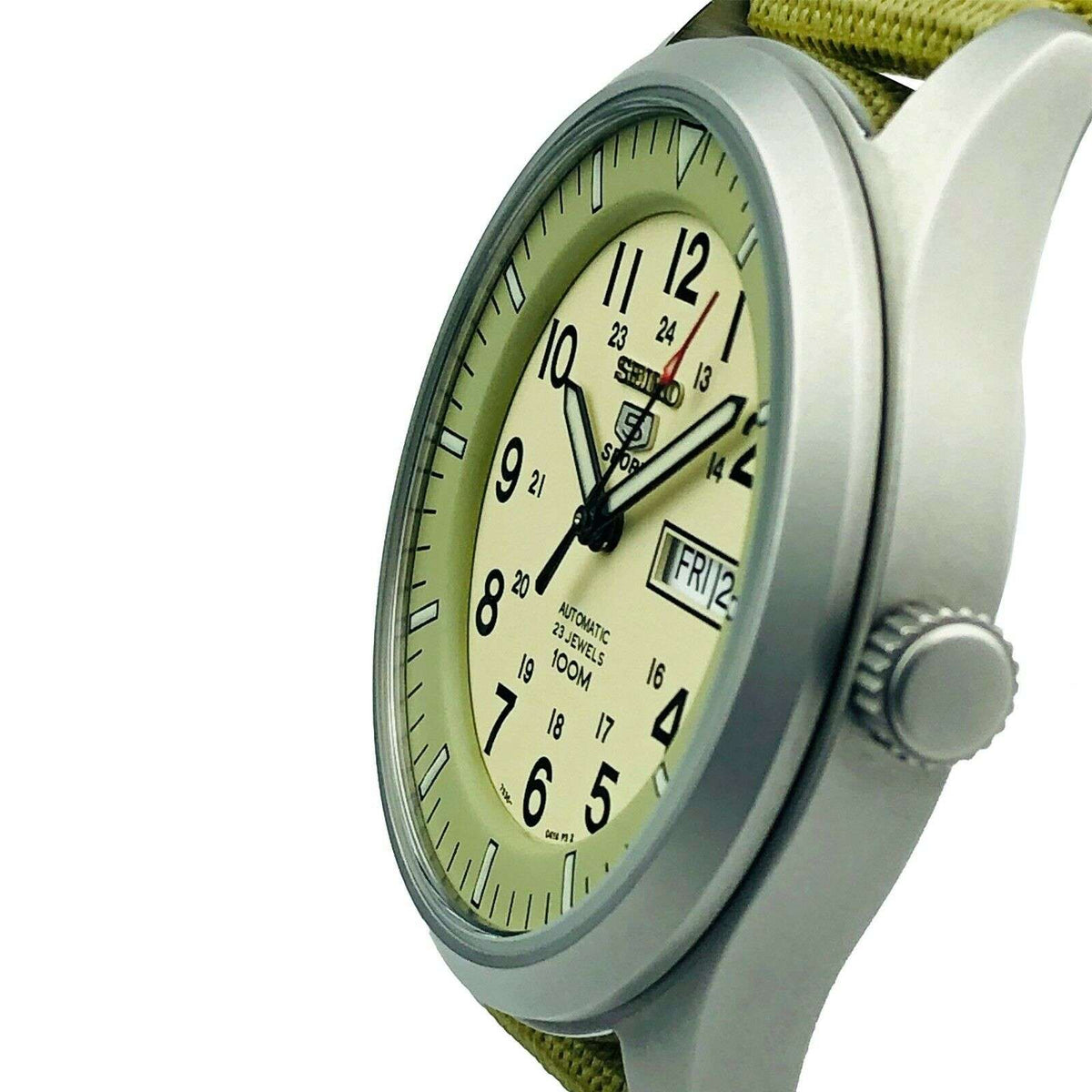 Seiko 5 Sports automatic watch with cream dial and green canvas strap in 3/4 view