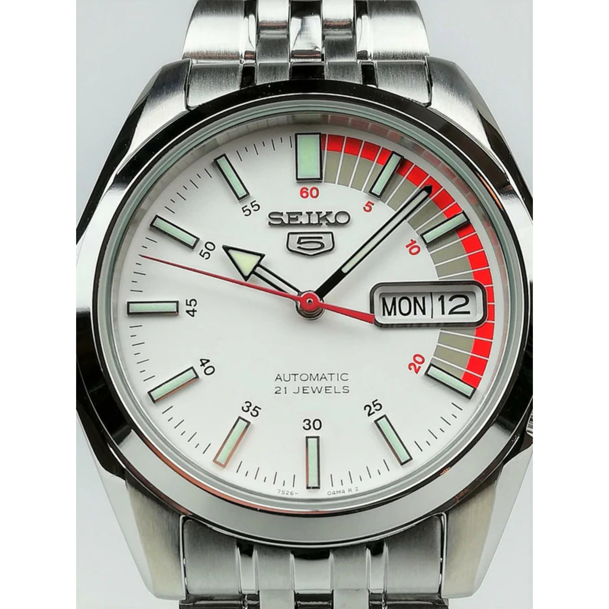 Seiko 5 Automatic SNK369K1 close-up detailing the luminous hour markers, red seconds hand, and day-date window at 3 o'clock