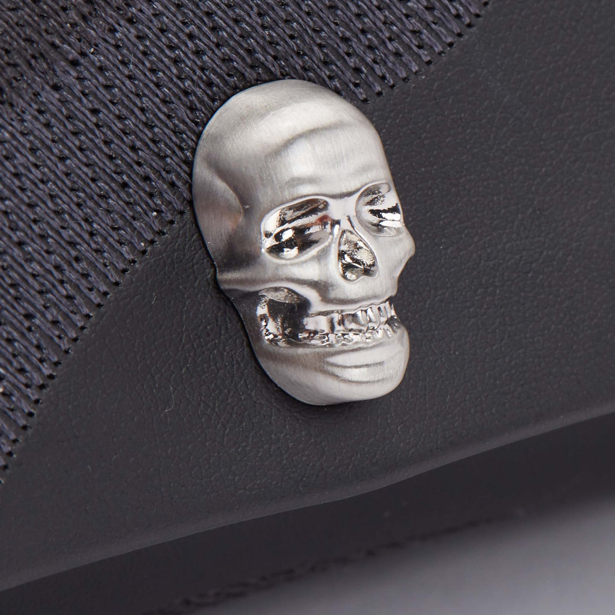 Silver wolf skull emblem on dark watch roll fabric