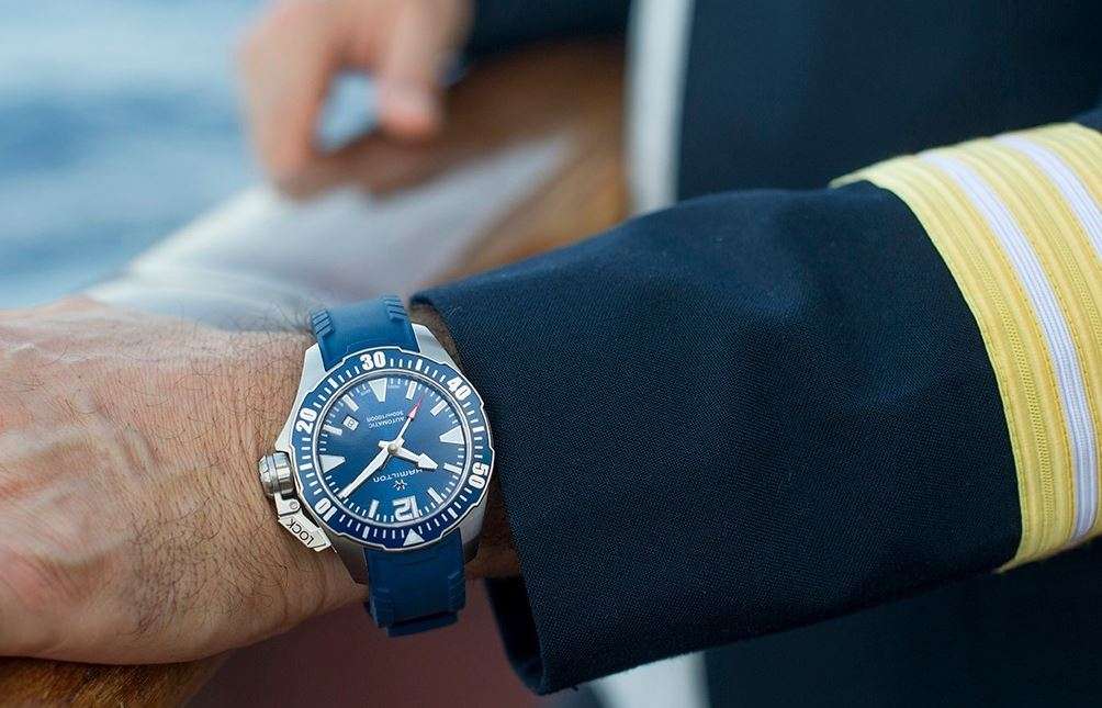 Hamilton diver watch on wrist, blue dial with blue silicone strap