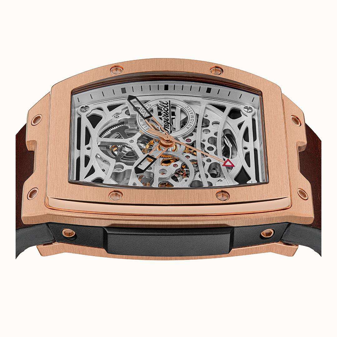 Rose-gold skeleton watch angled view showing gearwork through the clear dial window.