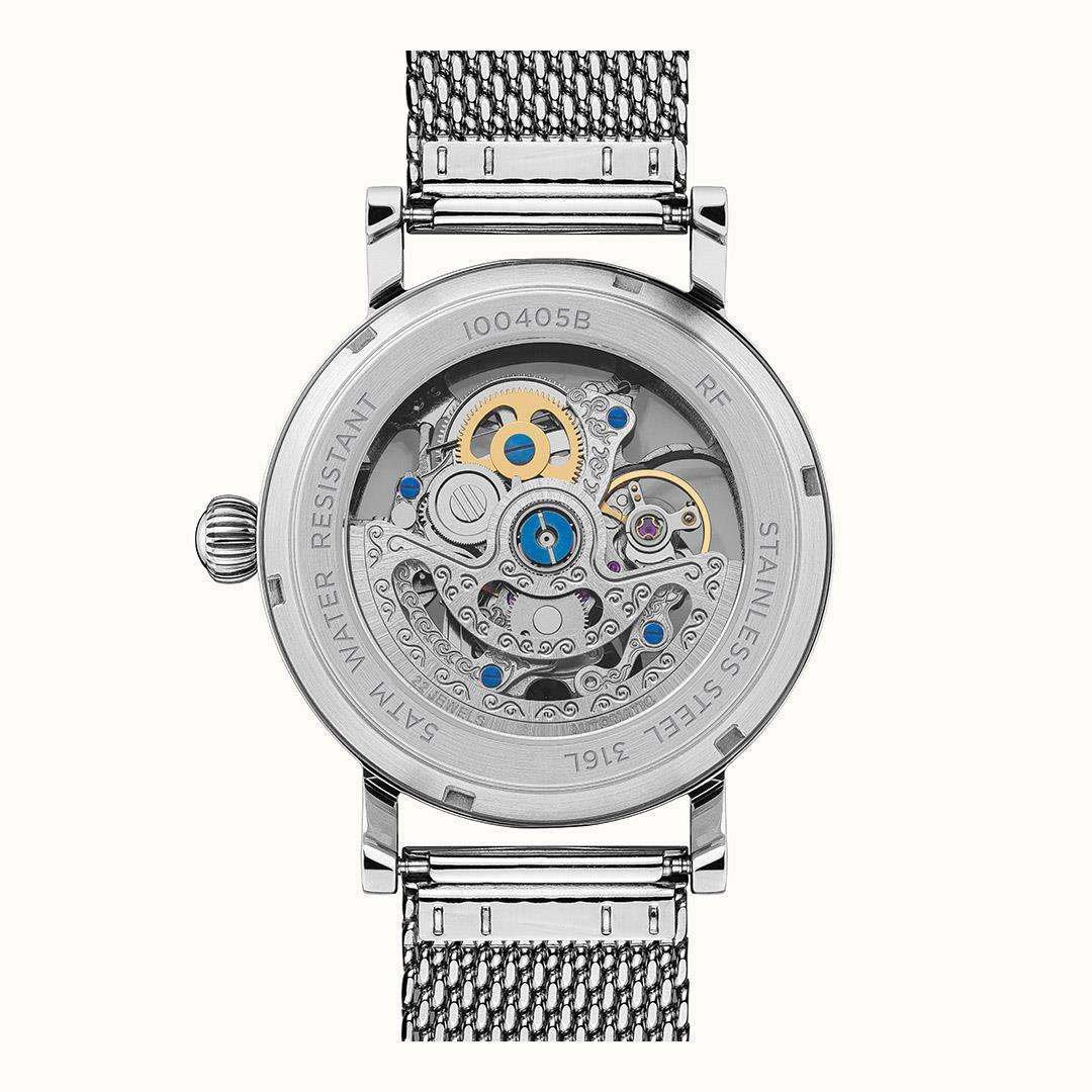 Men's automatic watch back with engraved markings and skeleton mechanism, silver case.