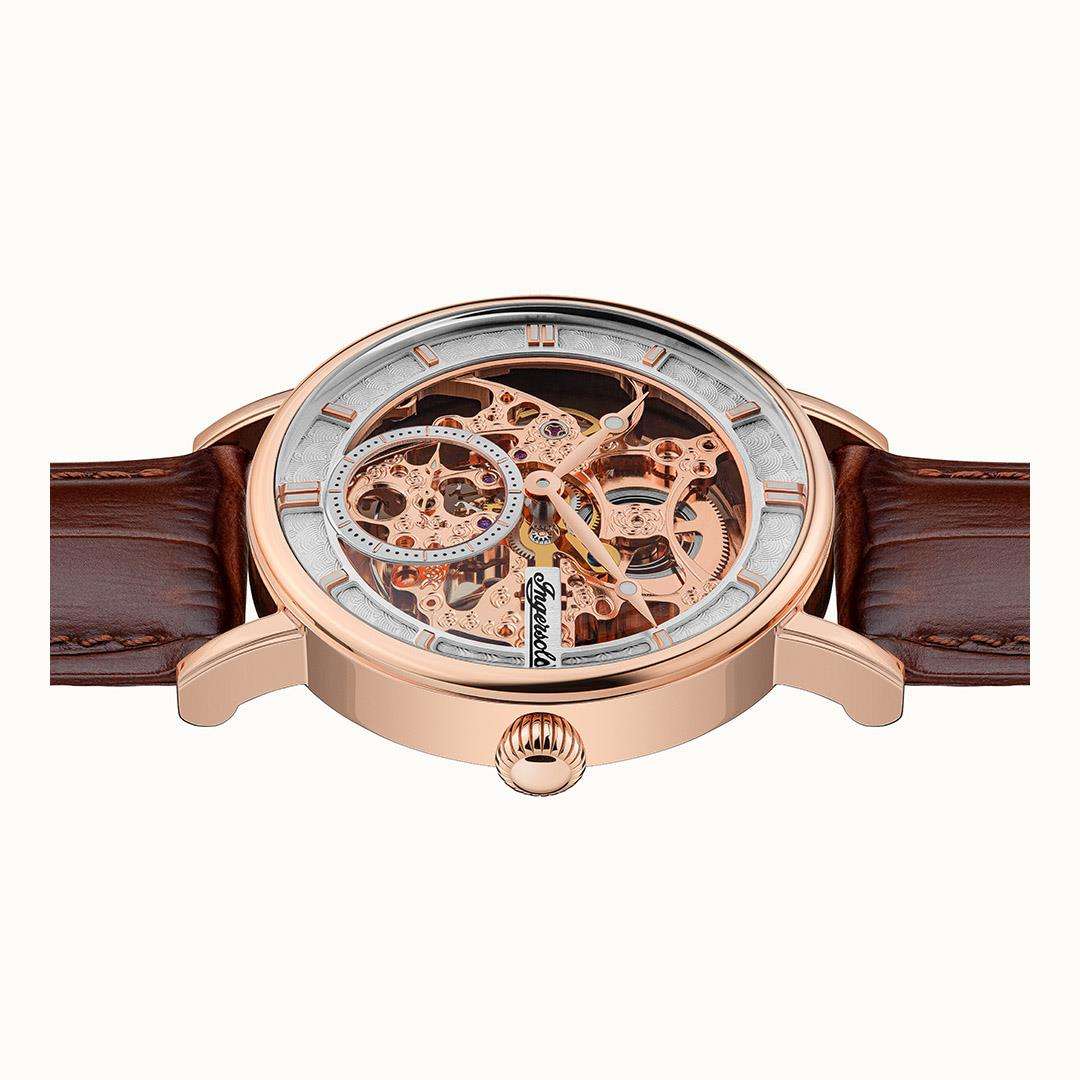 Automatic watch front view showing open-work dial, rose-gold case, and brown leather strap