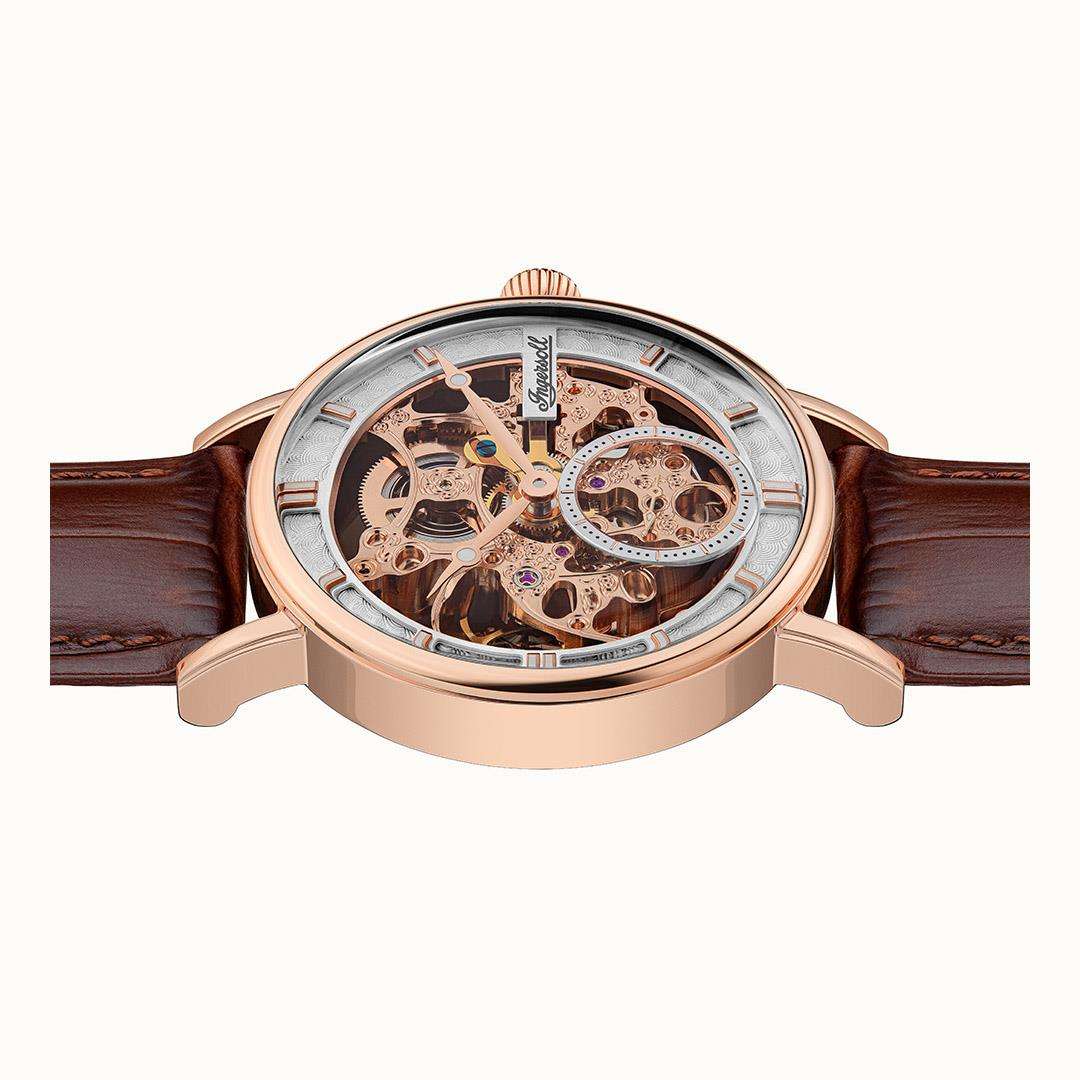 Automatic watch front view with skeleton dial and visible gears; brown leather strap